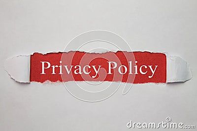 Privacy Policy word on the torn paper. Stock Photo