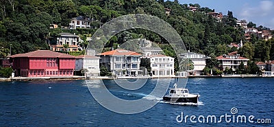 Private boat on sea and so many houses on mountains Editorial Stock Photo
