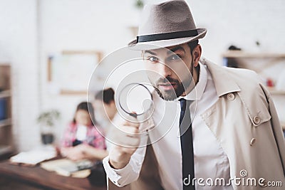 Private detective agency. Man is posing with magnifying glass, woman is holding her daughter. Stock Photo