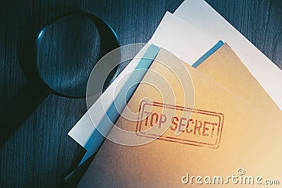 Private detective desk with envelopes labeled as top secret Stock Photo