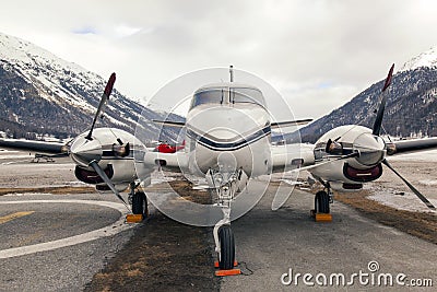 Private jets and a helicopter in the airport of St Moritz Switzerland Stock Photo