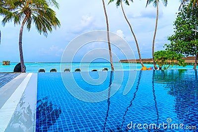 Private oceanfront pool with submerged loungers in a luxury reso Stock Photo