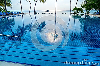 Private oceanfront pool with submerged loungers in a luxury reso Stock Photo