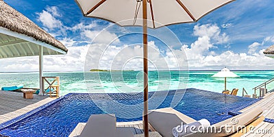 Luxury resort or hotel with beach chair with umbrella on private pool, ocean view. Exotic travel destination, summer vacation Stock Photo