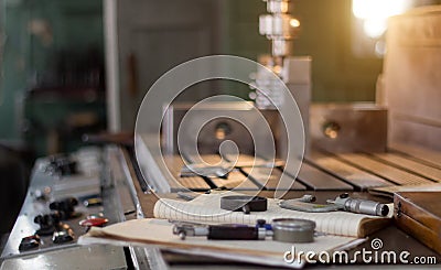 A private workshop for working with metal parts, in the background a drilling machine drills a hole in the pulley, on Stock Photo