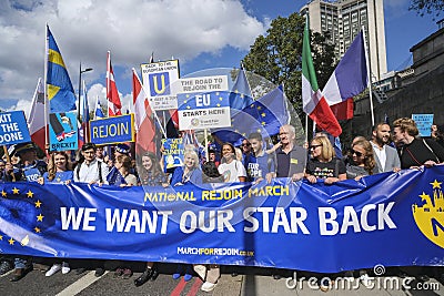 Pro-EU anti-Brexit supporters with main banner at the National Rejoin March in London. Editorial Stock Photo