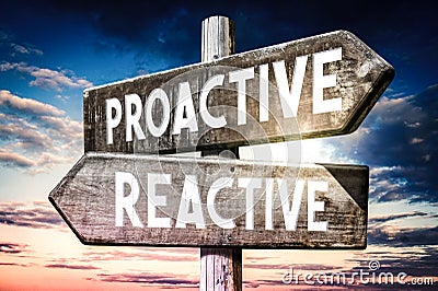 Proactive, reactive - wooden signpost, roadsign with two arrows Stock Photo