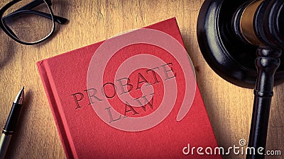 Probate law book on wooden table surrounded with gavel, glasses and pen. Law concept Stock Photo