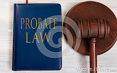 PROBATE LAW - words on a dark blue book on a light wooden background with a judge's hammer on the stand Stock Photo