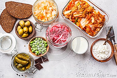 Probiotics food concept. Kimchi, beet sauerkraut, sauerkraut, cottage cheese, peas, olives, bread, chocolate, kefir and pickled Stock Photo