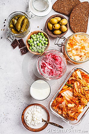 Probiotics food concept. Kimchi, beet sauerkraut, sauerkraut, cottage cheese, peas, olives, bread, chocolate, kefir and pickled Stock Photo