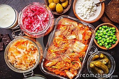 Probiotics food concept. Kimchi, beet sauerkraut, sauerkraut, cottage cheese, peas, olives, bread, chocolate, kefir and pickled Stock Photo