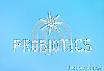 Probiotics word and sun made of pills on blue background Stock Photo