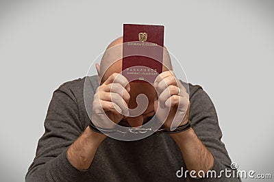 The problem of illegal immigration refugees Colombia, Colombian immigrant handcuffed with a passport in his hands. Illegal border Stock Photo