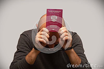 The problem of illegal immigration of refugees from Russia, a Russian immigrant in handcuffs. Illegal border crossing, border tres Stock Photo