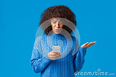 Problem, messaging and people concept. Confused and displeased, tensed african-american young woman receive strange Stock Photo