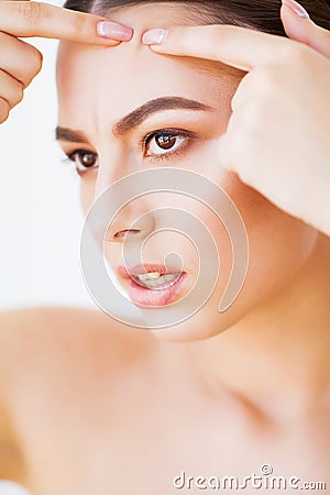Problem Skin. Woman Crushing Spot On Face And Looking In Mirror Stock Photo