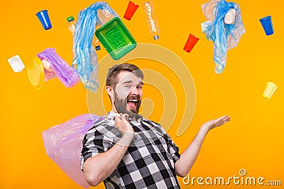 Problem of trash, plastic recycling, pollution and environmental concept - funny man holding garbage for recycling on Stock Photo