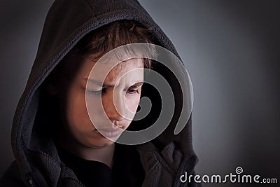 Problems of teenagers, Sad child sitting in a dark room thinks Stock Photo