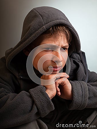 Problems of teenagers, Sad child sitting in a dark room thinks Stock Photo