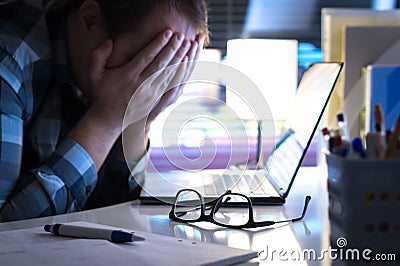 Problems at work. Sad, unhappy and tired man covering face. Stock Photo