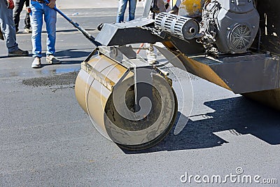 A procedure for installing asphalt on roads using asphalt special machines as well as heavy vibration roller pavements Stock Photo