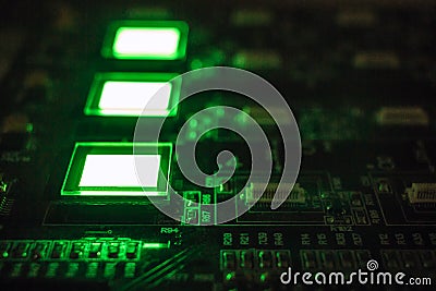 The process of checking several oled displays on the test station. Displays glow brightly of green color close up Stock Photo