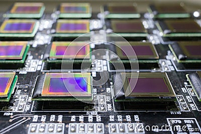 The process of checking several oled displays on the test station. The monitors is turn off and have rainbow on surface Stock Photo