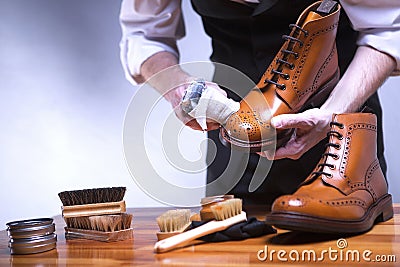 The process of cleaning shoes. A man is cleaning his shoes. Stock Photo