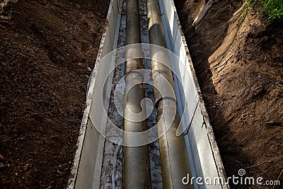 Process of construction of heating pipelines. Jointed steel pipes insulated with polymer-mineral insulation in concrete Stock Photo