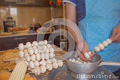 Process of cooking a delicious mushrooms - hands Stock Photo