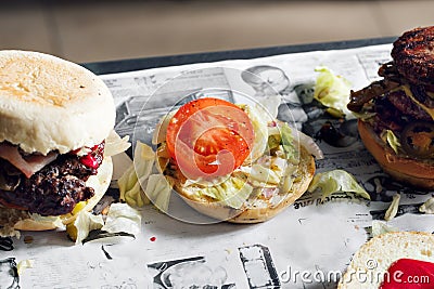 Process of cooking hamburger. chef on the kitchen table making out the ingredients of the Burger. Beef Patty cooked on Stock Photo