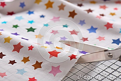 Process cutting fabric by scissors on craft mat Stock Photo