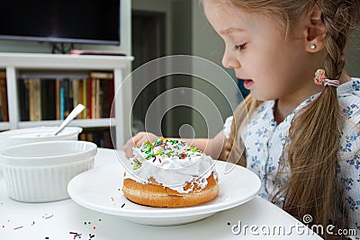 Process of decorating a cake with sweet colored decorations Stock Photo