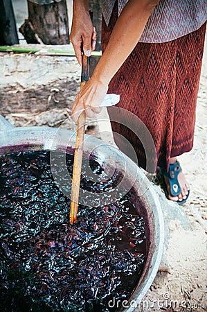 Process of dyeing silk in large pan in Thailand Stock Photo