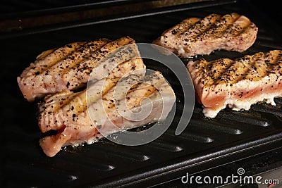 The process of frying salmon fillets at home Stock Photo