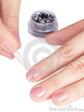 Process of gluing small paste on nail Stock Photo