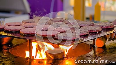 Process of grilling meat cutlets for burgers on brazier with hot flame Stock Photo