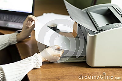 The process of inserting paper in laser printer cartridge Stock Photo