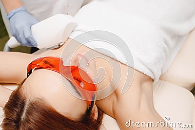 Process laser hair removal underarm treatment in salon young woman having. Stock Photo