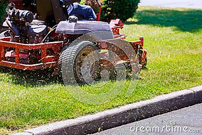 process of lawn mowing, concept of mowing the lawn, lawnmower cutting grass with gardening tools Stock Photo