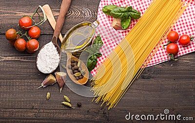 The process of making Food background for tasty Italian dishes with tomato. Various cooking ingredients with spaghetti and spoon. Stock Photo