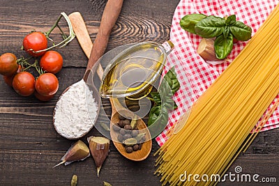 The process of making Food background for tasty Italian dishes with tomato. Various cooking ingredients with spaghetti and spoon. Stock Photo