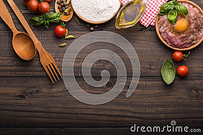 The process of making Food background for tasty Italian dishes with tomato. Various cooking ingredients with spaghetti and spoon. Stock Photo