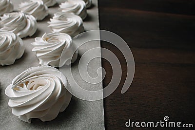 The process of making marshmallow. Close up hands of the chef with confectionery bag cream to parchment paper at pastry shop Stock Photo