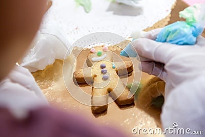 The process of making Sandman the cookies manually apply the glaze of your children& x27;s hands Stock Photo