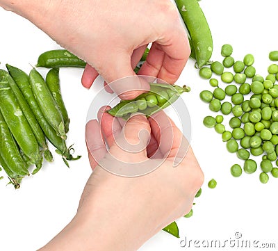 Process of manual cleaning of green peas on white background Stock Photo