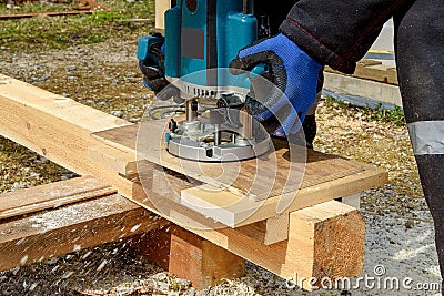 The process of milling wood with a circular machine. Passion for wood carving. Golden hand Stock Photo