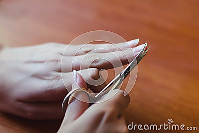 The process of nail clipping scissors. Hand care concept. Stock Photo