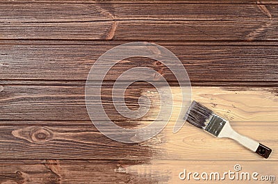 The process of painting wood surfaces with a brush. Unfinished p Stock Photo